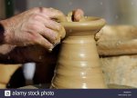 clay-vase-being-made-on-a-potters-wheel-at-a-craft-fair-AM2MYK.jpg
