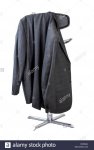 black-leather-and-chrome-bar-stool-on-a-white-background-with-a-mans-suit-jacket-hanging-on-th...jpg