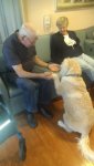 Beau shaking a paw with residents.jpg
